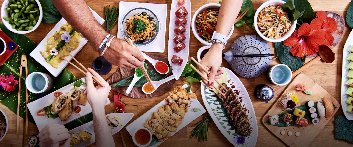 Woman holding sushi with chopsticks